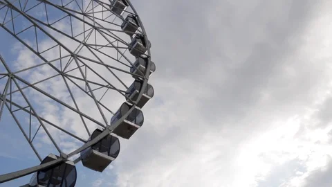 Cabins Ferris Wheel rotating on a cloudy sky background. Stock Footage 88923209