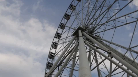 Cabins Ferris Wheel rotating on a cloudy sky background. Stock-Footage 88923646