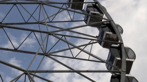 Cabins Ferris Wheel rotating on a cloudy sky background. Stock Footage 88923768