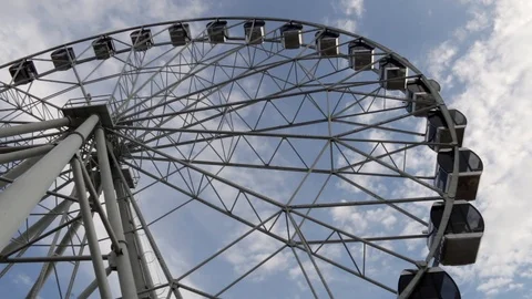 Cabins Ferris Wheel rotating on a cloudy sky background. Stock Footage 88923889