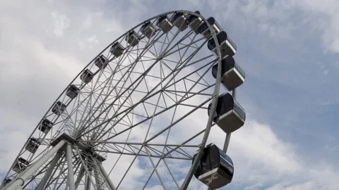 Cabins Ferris Wheel rotating on a cloudy sky background. Stock Footage 88924077