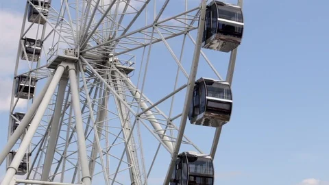 Cabins Ferris Wheel rotating on a cloudy sky background. Stock Footage 88924170