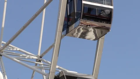 Cabins Ferris Wheel rotating on a cloudy sky background. Stock Footage 88924311