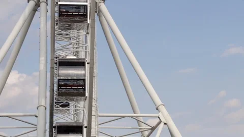 Cabins Ferris Wheel rotating on a cloudy sky background. Stock Footage 88924479