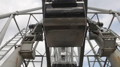 Cabins Ferris Wheel rotating on a cloudy sky background. Bottom view. Stock Footage 88924720