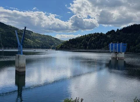 Cable bridge leading to the control center at a reservoir. Stock Photos