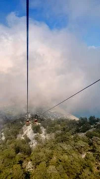 Cable Car Above Forested Mountain and Clouds in Antalya Turkey Stock Photos