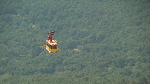 On cable car among rocks on Mount Ai-Petri moving yellow cabin. Stock Footage 106607865