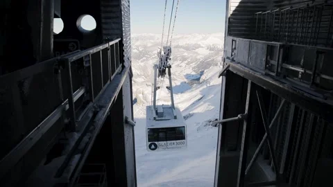 Cable car and ski lift starts of downhill ride in the region of the Diablerets Stock Footage 224537361