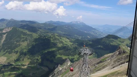 Cable car ascending to mountain peak in Swiss mountains, establisher Stock Footage 279058394