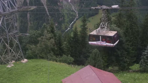 Cable car ascends to Swiss mountain village Stock Footage 52456653
