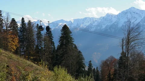 Cable car in autumn. cabins move against the background of mountains Stock Footage 221179871