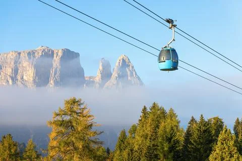 Cable car cabin over the trees on the background  of Punta Euringer mountain Stock Photos