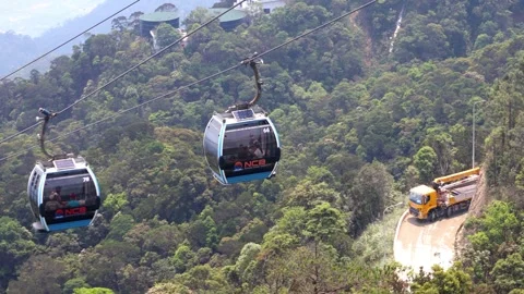 The cable car cabin rides over the hilly landscape Stock Footage 341481709