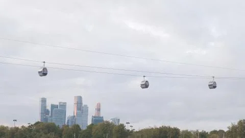 Cable car cabins cabins on the background of skyscrapers of the business center. Stock Photos