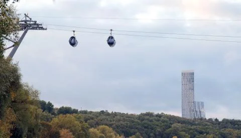 Cable car cabins cabins on the background of skyscrapers. Stock Photos