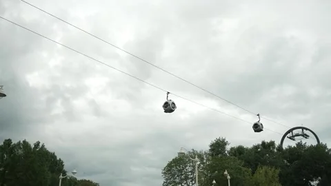 Cable car cabins fly over the city. Filmed in motion Stock Footage 336795338