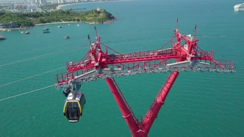 The cable car cabins pass by with a view of the sea and a cruise liner Stock-Footage 286030889