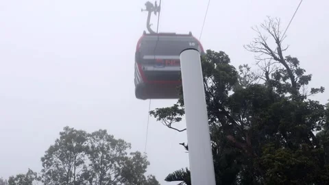 Cable car cabins ride on a hill in a white cloud Video stock 312911968