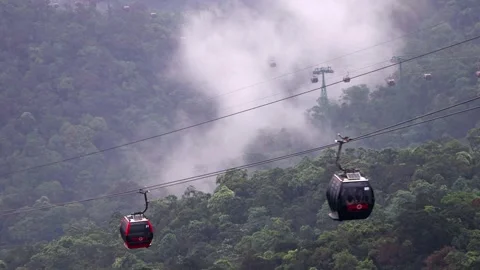 Cable car cabins ride on a hill in a white cloud Stock Footage 314061906