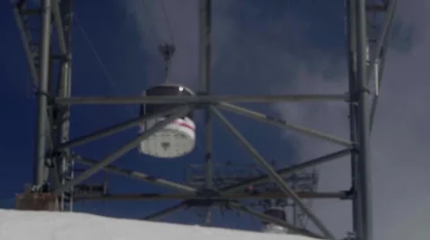 Cable car that climbs passing through the giant metal poles on the steep slop Stock Footage 68941714
