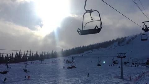 Cable car climbs up the ski slope on the background of beautiful sky, the forest Stock Footage 74196077
