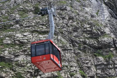 A cable car coming down the mountain Stock Photos