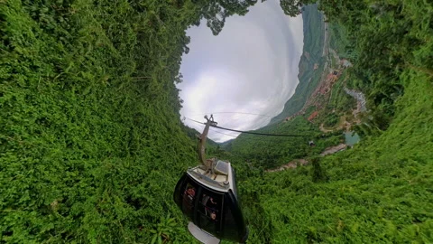 Cable Car Descending into Deep Green Valley with Swirling 360 Degree Curve Effec Vídeos de archivo 323474258
