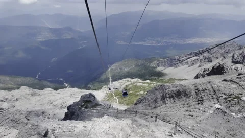 Cable Car Descent over Rocky Mountain Slope with Valley and Forest Stock Footage 340131503