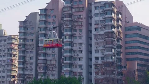 A cable car floating past residential buildings. Stock Footage 329143802