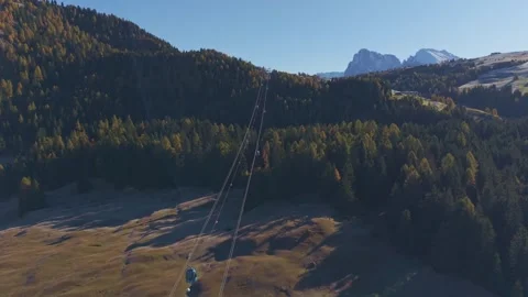 Cable car glides above Dolomites with breathtaking sunny view, drone. Stock Footage 321550946