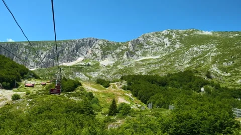 Cable car glides through emerald forested valleys. Savin Kuk peak, Montenegro Video stock 342981122