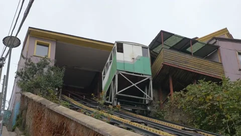 A cable car goes up in the working class neighborhoods of Valparaiso, Chile Stock Footage 237040120