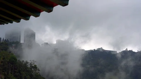 Cable car going up to buildings with clouds flowing over them Stock Footage 91122996