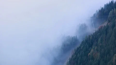 Cable car gondolas moving across mountain hill from misty cloud to the top 스톡 동영상 126589592