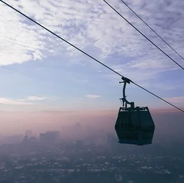 Cable car on the line during sunset in the fog Foto stock