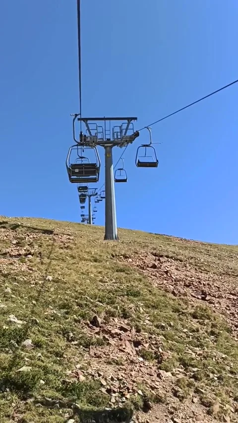 A cable car moving on a mountain and a blue sky background. Stock Footage 288141416