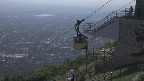 The cable car is moving with the people in the background of the city Pyatigorsk Stock Footage 301775194