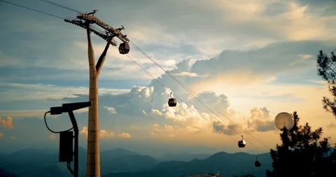 Cable car over mountains with beautiful clouds in background Stock Footage 130064586