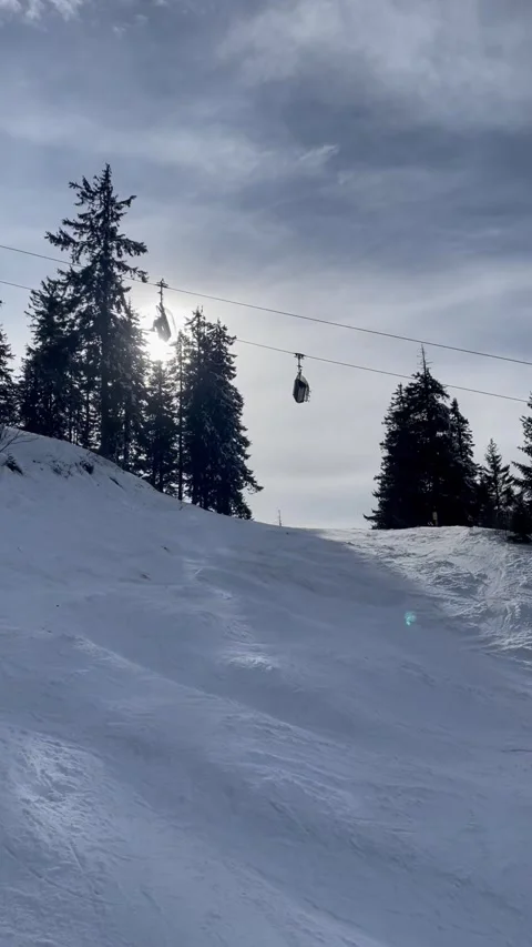 Cable Car Over Snowy Ski Slope in Poiana Brasov, Romania Stock Footage 327537762