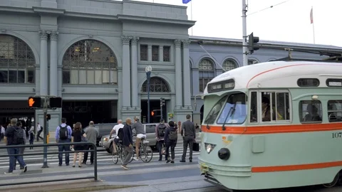 Cable car passes by The San Francisco Ferry Building in San Francisco Stock Footage