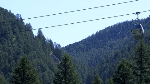 A cable car passes through the swiss alps Stock Footage 114823559