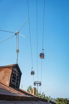 Cable car passing over old buildings and rooftops in Tbilisi, Georgia Photos