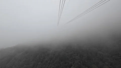 Cable car ride in the mountains with clouds Видео 295086452