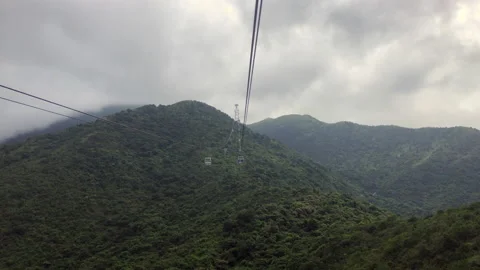 Cable car ride Ngong Ping 360 Hong Kong on rainy hazy cloudy day Stock Footage 133544707