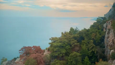 Cable car ride overlooking the ocean cliff at sunset Stock Footage 267576414