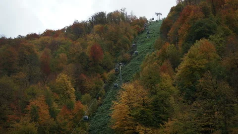 Cable car road at mountain landscape with white clouds at the top in autumn. Stock Footage 221179260