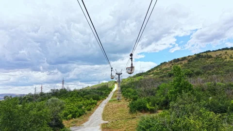 Cable car route runs through a green landscape with trees and clouds, leading Stock Footage 341130953