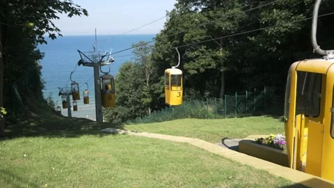 Cable car by the sea, cable car cabins go down to the sea, calm sea and beach Stock Footage 165730071