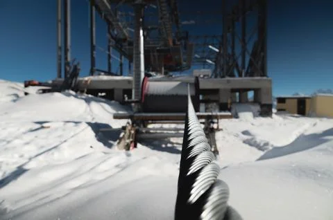 A cable car station under construction high in the mountains in winter. Focus on Stock Photos